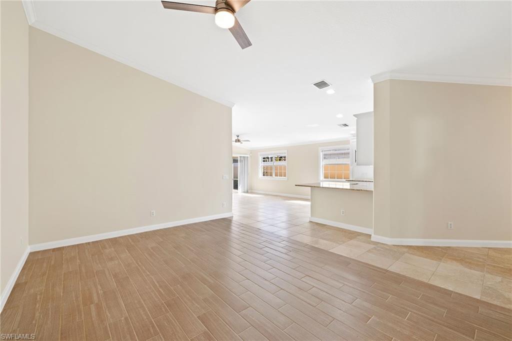 7539 Novara Court Naples, FL 34114 - Photo 12 of 30 a view of empty room with wooden floor