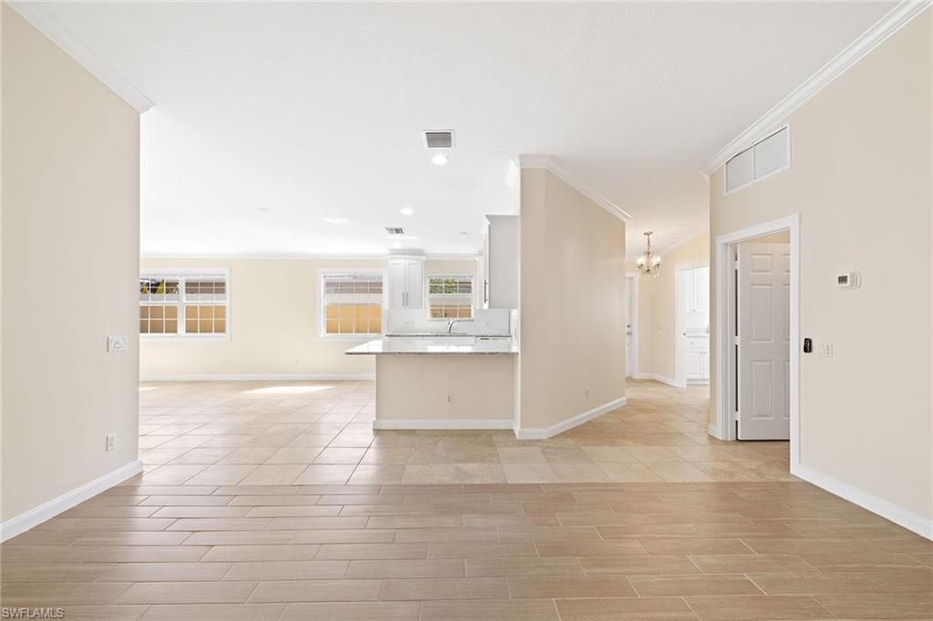 7539 Novara Court Naples, FL 34114 - Photo 13 of 30 a view of an empty room with kitchen and window