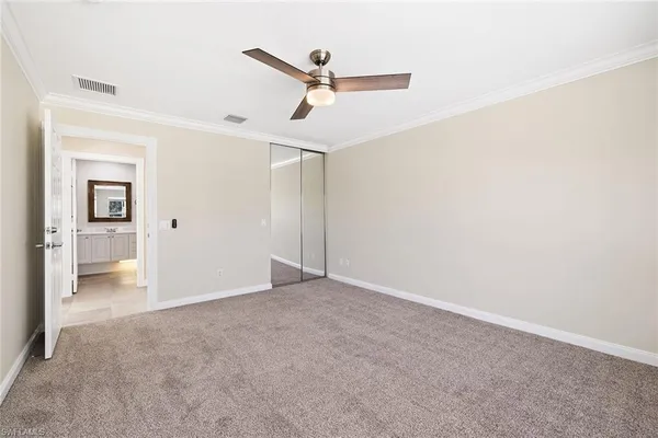 a view of a big room with closet and windows