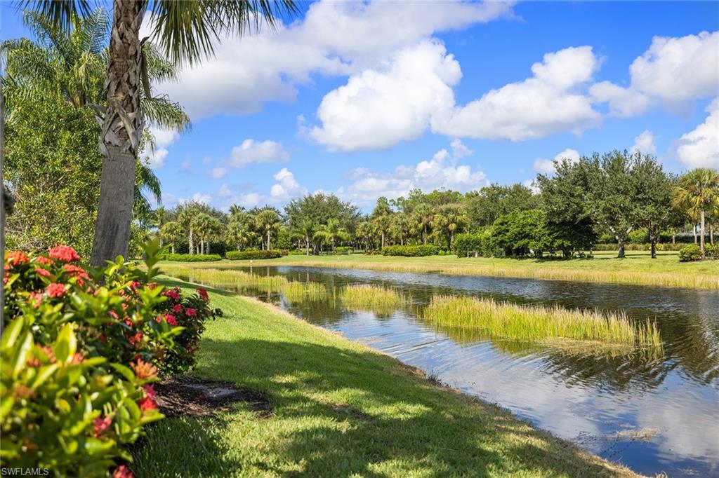 7539 Novara Court Naples, FL 34114 - Photo 29 of 30 a view of a lake with a beach