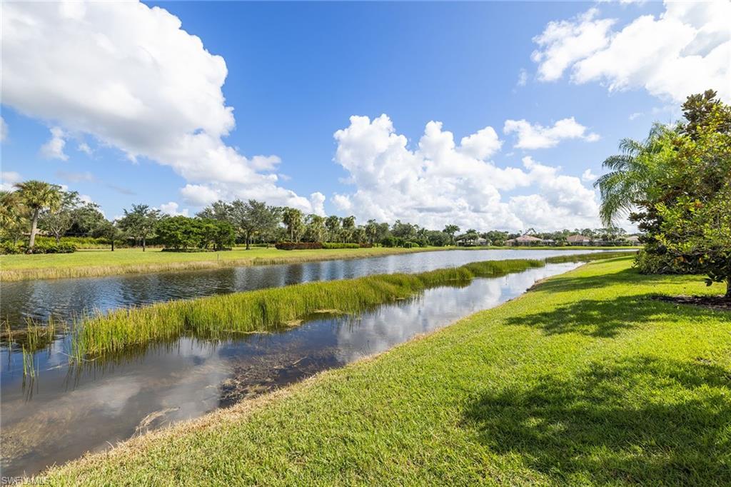 7539 Novara Court Naples, FL 34114 - Photo 30 of 30 a view of a lake with houses in the back