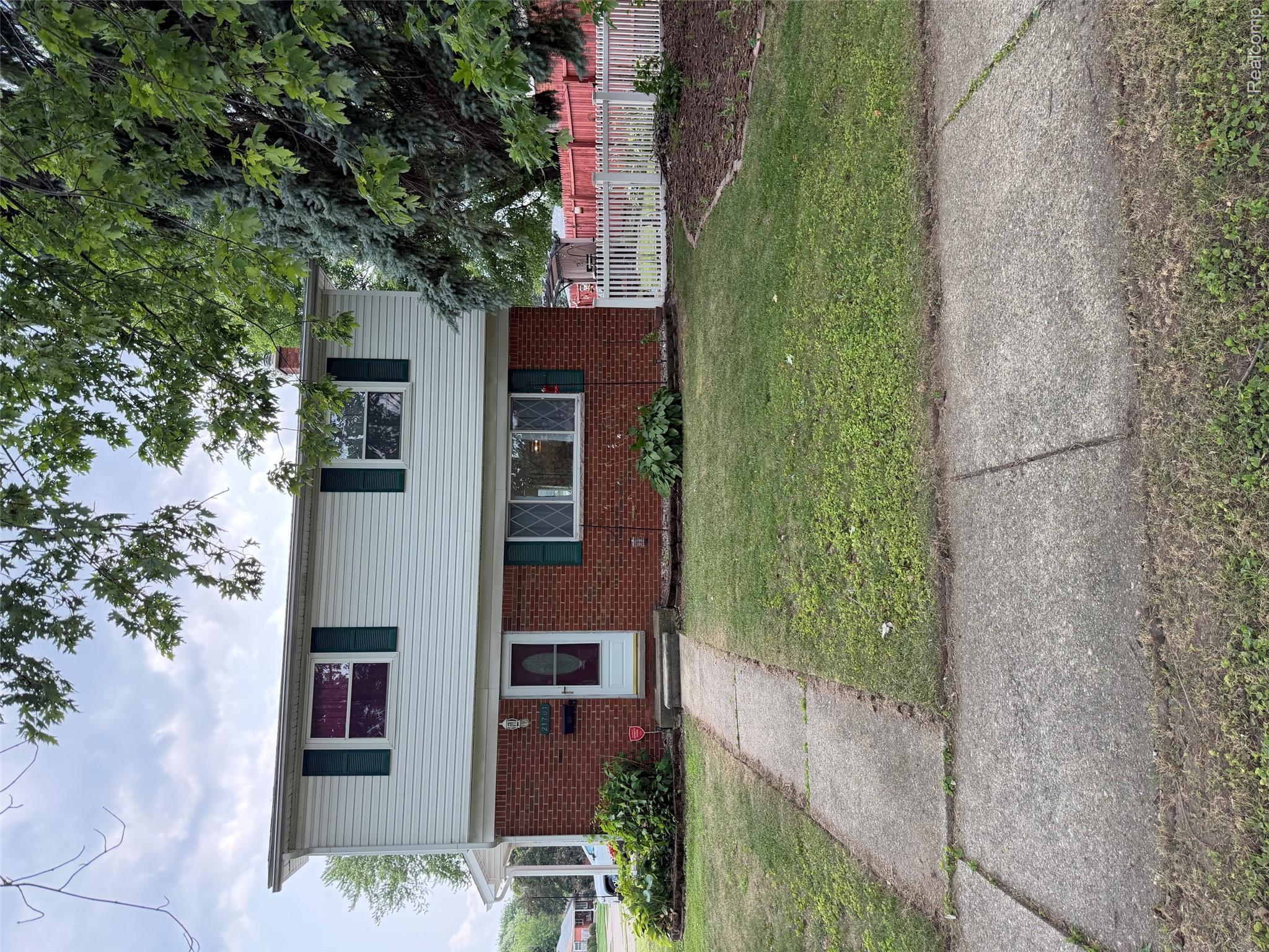 21701 Wick Road Taylor, MI 48180 - Photo 1 of 1 Two-story residence featuring white siding and red brick accents