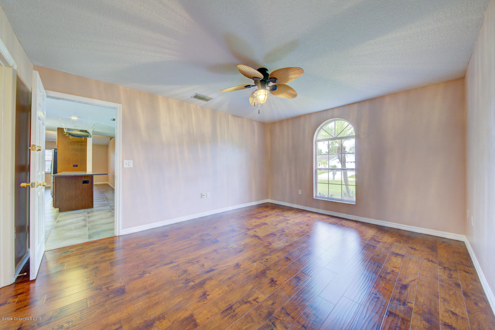 5544 Flint Road Cocoa, FL 32927 - Photo 21 of 48 wooden floor in an empty room with a window
