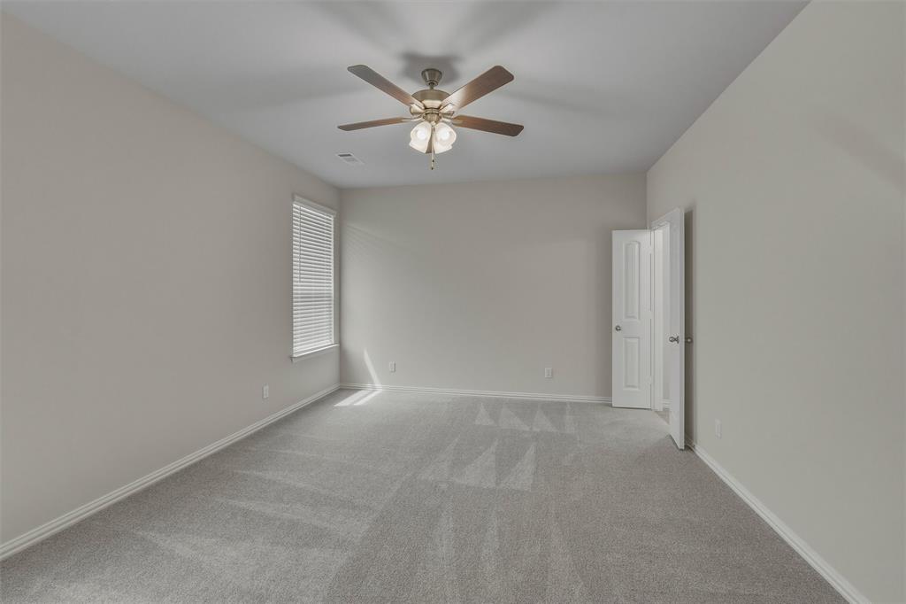 1325 Frio Drive Springtown, TX 76082 - Photo 12 of 24 Spacious room featuring neutral carpeting, light-toned walls, and a ceiling fan with integrated lighting