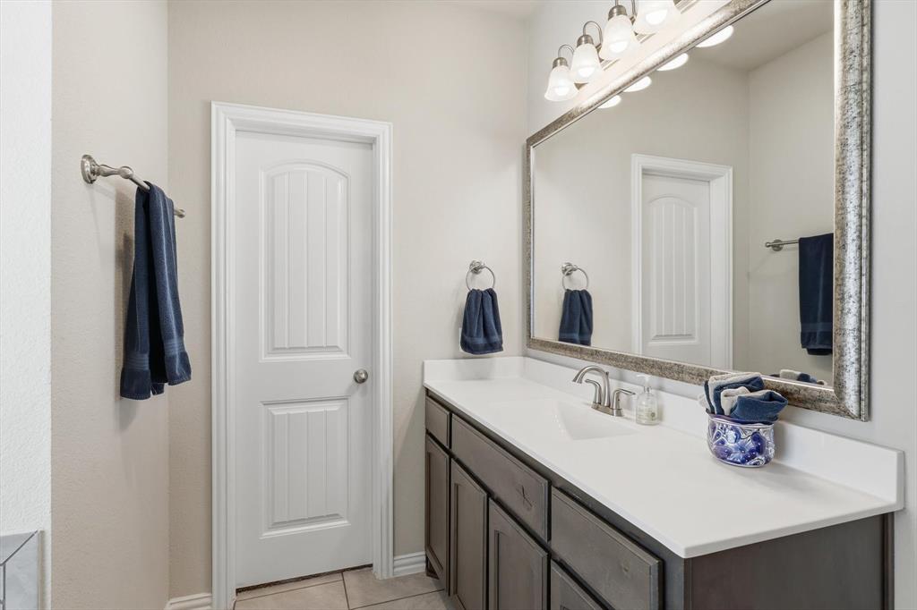 113 Heather Lane Decatur, TX 76234 - Photo 19 of 32 a bathroom with a sink vanity and a mirror