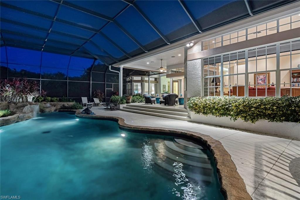 a swimming pool view with a outdoor seating