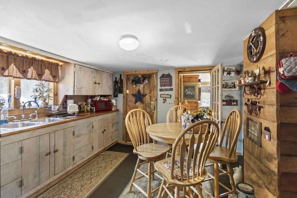 477 Podunk Road East Brookfield, MA 01515 - Photo 10 of 29 a view of a kitchen and dining area with chandelier