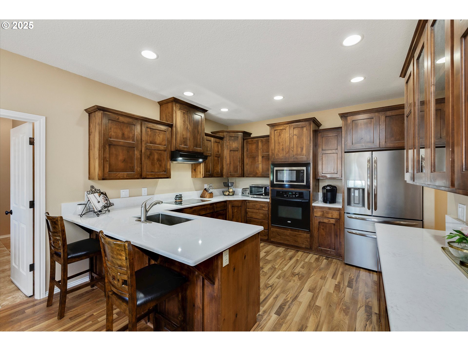 125 Telford Road Oregon City, OR 97045 - Photo 17 of 42 a kitchen with refrigerator cabinets and wooden floor