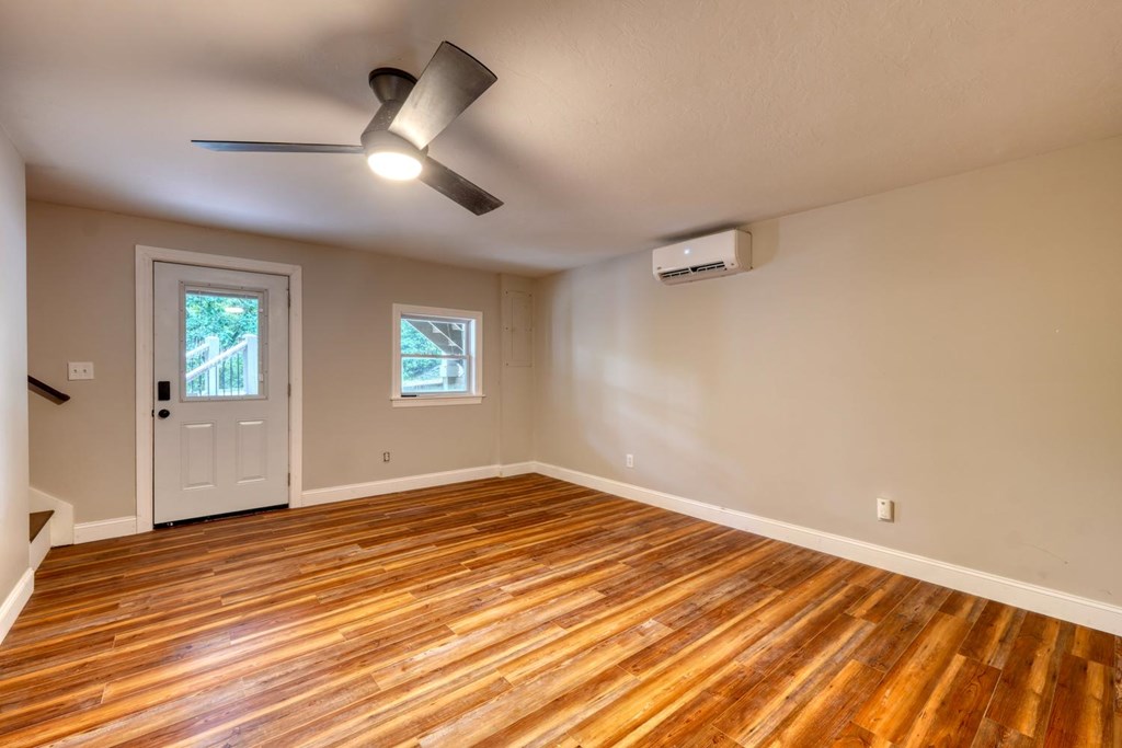45 Mountain Stream Road Murphy, NC 28906 - Photo 3 of 33 an empty room with wooden floor chandelier fan and windows