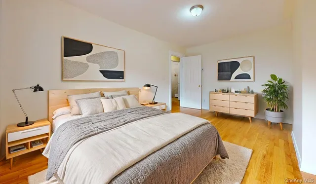 a bedroom with a bed and a potted plant