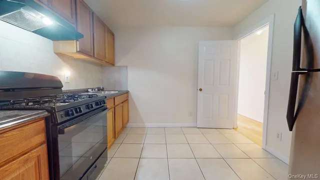 a kitchen with a stove a refrigerator and cabinets