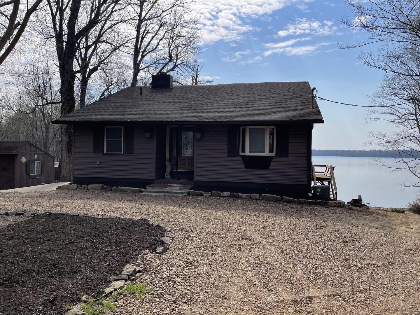 3512 Riverview Lake Road Metropolis, IL 62960 - Photo 2 of 20 a backyard of a house with large trees and a tree