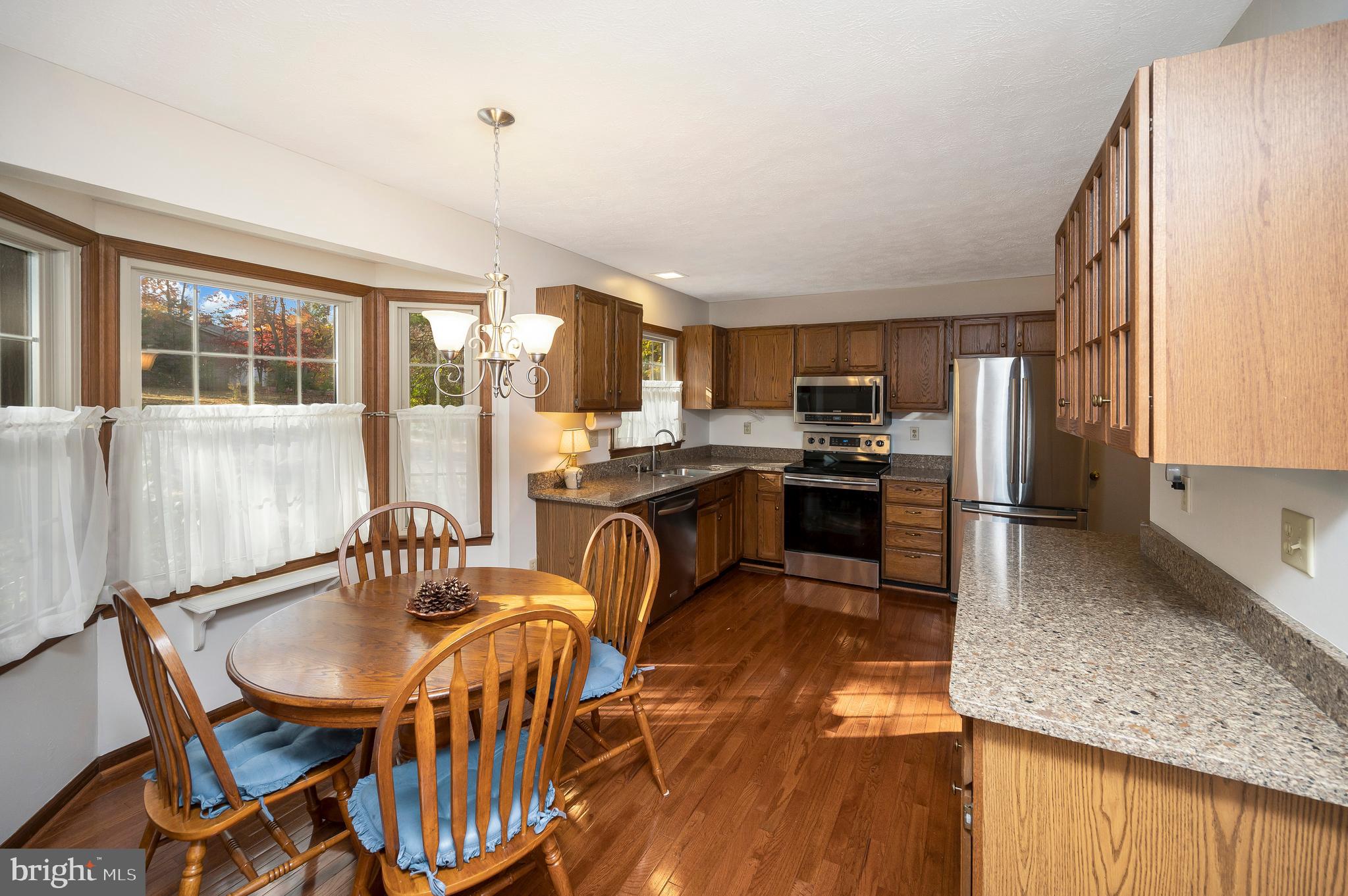 104 Appleview Court Locust Grove, VA 22508 - Photo 13 of 65 a kitchen with stainless steel appliances granite countertop a stove a sink a microwave and a dining table