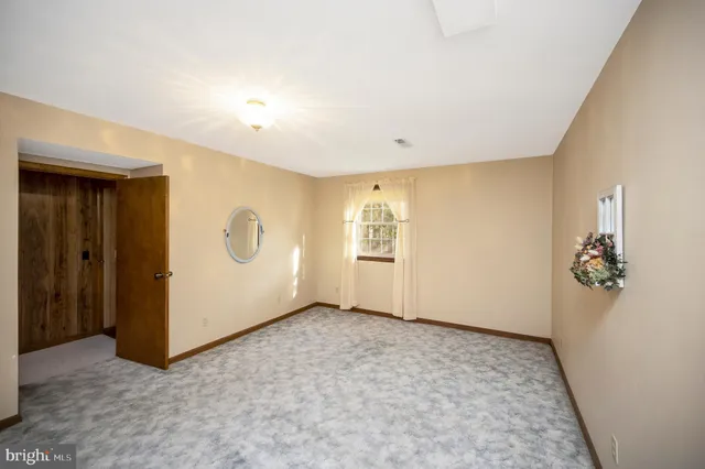 a view of a park with a house in the background