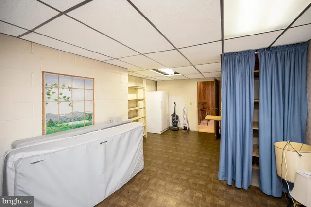 a view of a yard in front of a house with large trees