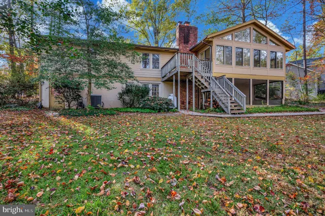 a view of a house with a yard and tree s
