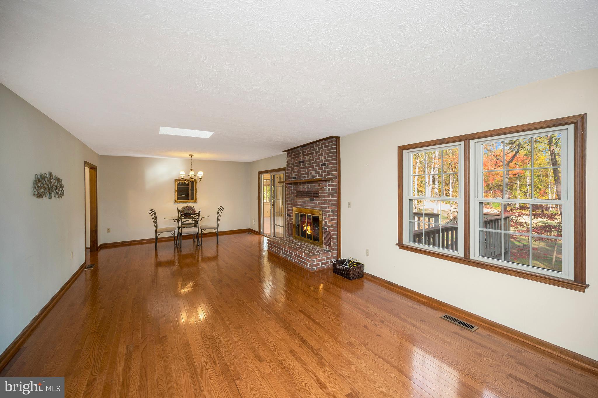 104 Appleview Court Locust Grove, VA 22508 - Photo 7 of 65 a view of a livingroom with furniture a fireplace and wooden floor