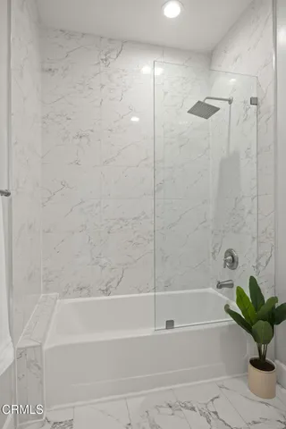 a bathroom with a bathtub and a shower