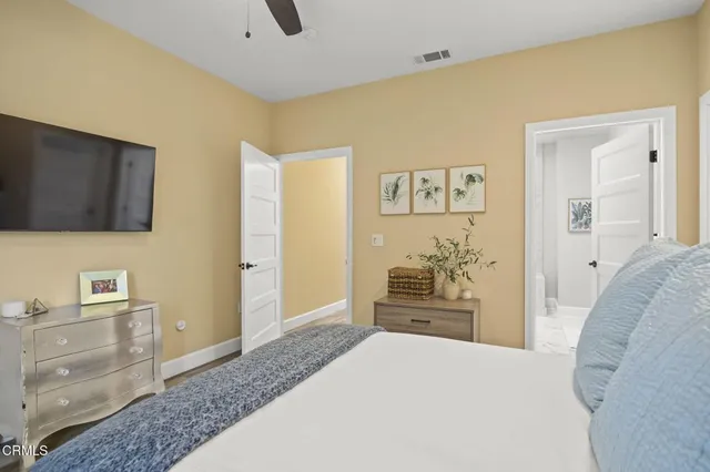 a bedroom with a bed and a flat screen tv