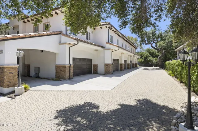 a view of a white house with a outdoor space