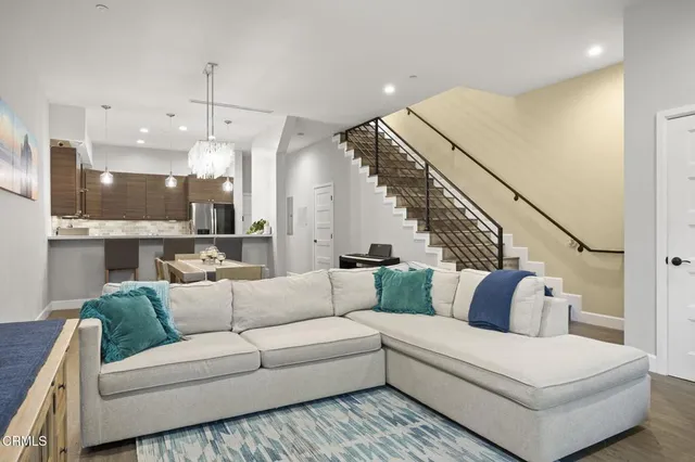 a living room with furniture and kitchen view