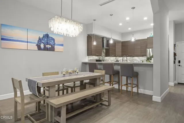 a view of a dining room with furniture and chandelier
