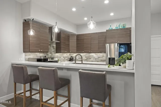 a kitchen with counter top space and dining table