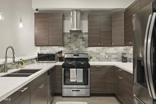 a kitchen with a sink stove and refrigerator