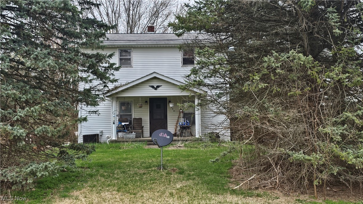 36354 Butternut Ridge Road North Ridgeville, OH 44039 - Photo 1 of 10 View of front of property featuring a chimney, a front lawn, and covered porch