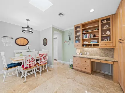a living room with patio furniture and a potted plants
