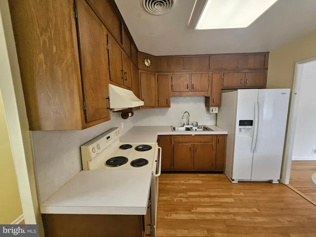 a kitchen with a refrigerator and a stove