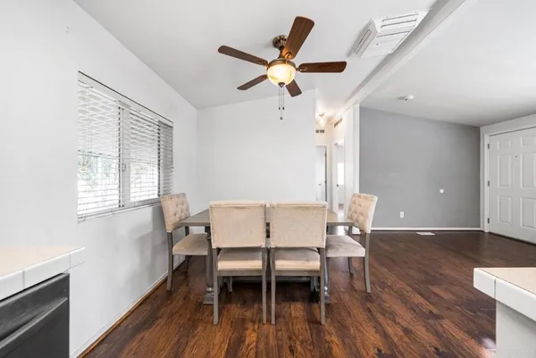 a workspace with wooden floor and a window