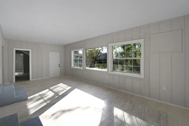 a view of wooden floor and windows in a room