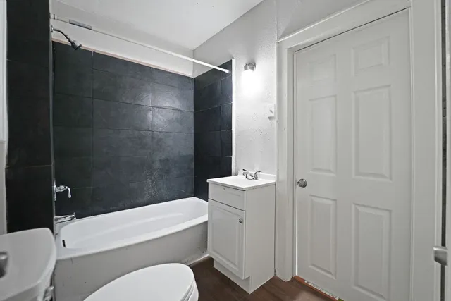 a bathroom with a toilet a sink and bathtub