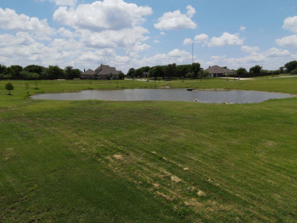 3322 Mariposa Ridge Crowley, TX 76036 - Photo 30 of 34 a view of a golf course with a lake