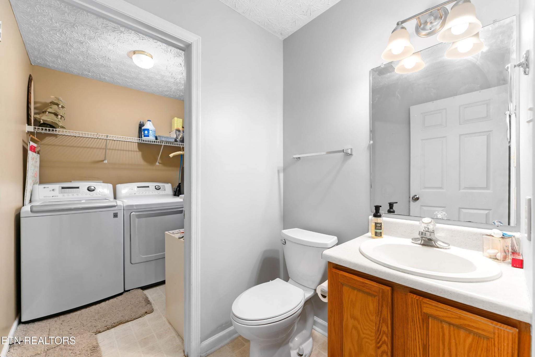 1935 Poplar Hill Road Knoxville, TN 37922 - Photo 11 of 25 a bathroom with a sink toilet and a mirror