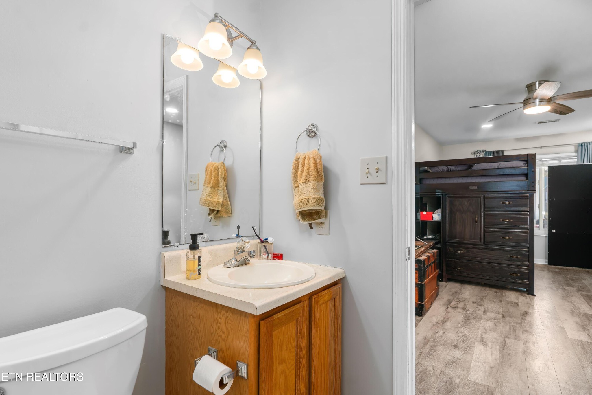 1935 Poplar Hill Road Knoxville, TN 37922 - Photo 10 of 25 a bathroom with a sink vanity mirror and toilet