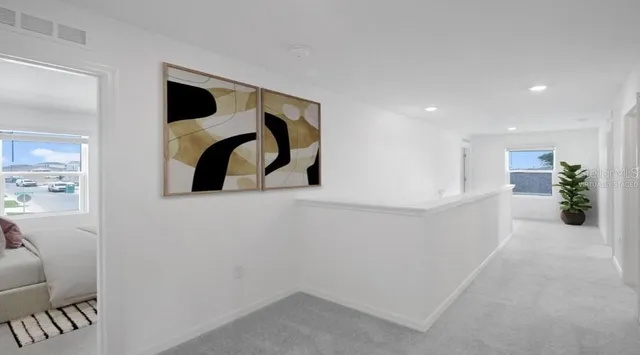 a bedroom with furniture and a flat screen tv