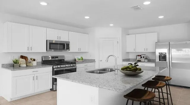 a large kitchen with a table and chairs