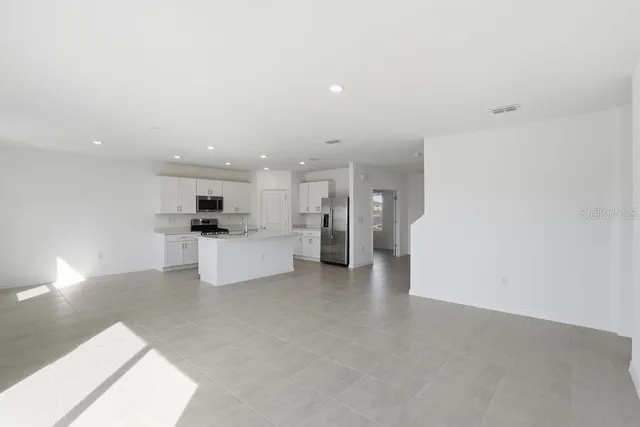 a view of kitchen with kitchen island and stainless steel appliances