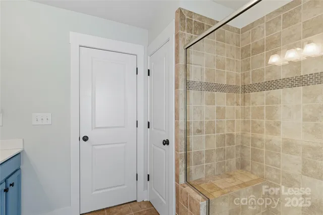 a bathroom with a granite countertop sink a mirror and a shower