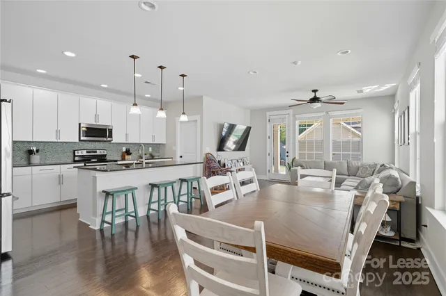a large white kitchen with lots of counter space and appliances