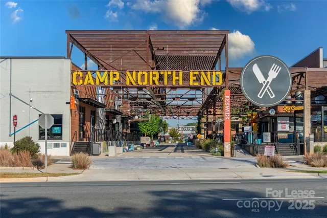 a front view of a building with street and sign board