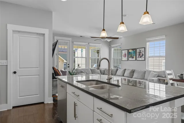 a view of a kitchen counter space a sink and appliances