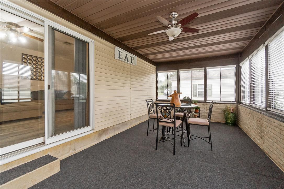 5728 Pheasant Road Bethlehem, PA 18017 - Photo 20 of 39 A spacious enclosed porch features textured walls, durable flooring, and large windows with integrated blinds.
