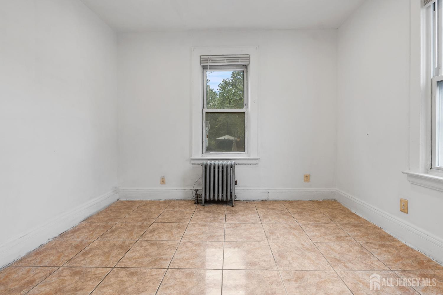 213 Maple Avenue, Unit 1 Irvington, NJ 07111 - Photo 12 of 17 an empty room with a window