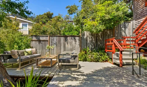a view of a backyard with sitting area