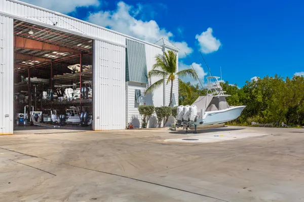 a front view of a house with garden and trees