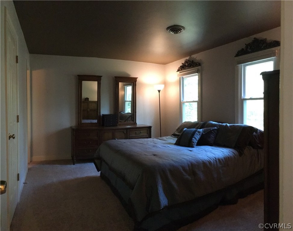 12236 Riverway Road Chesterfield, VA 23838 - Photo 29 of 44 a bedroom with a bed and a large mirror