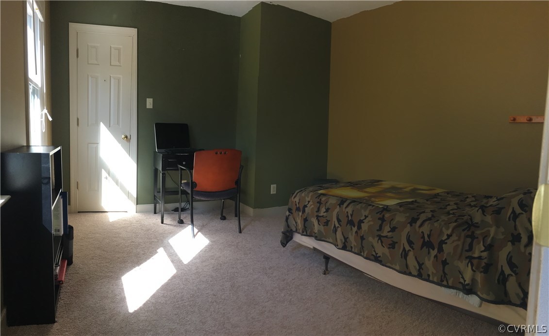 12236 Riverway Road Chesterfield, VA 23838 - Photo 33 of 44 a bed sitting in a bedroom next to a window
